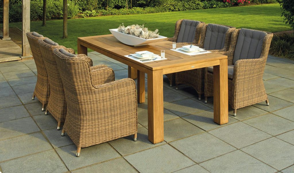 There is a set of tables and chairs outdoors