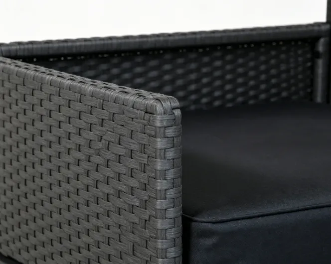 Close-up of woven rattan material and black fabric cushion
