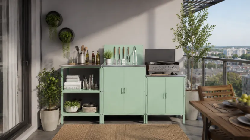 Mint green outdoor kitchen cabinets with a grill and storage on a city balcony